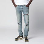 AMIRI MX1 distressed flannel-patched jeans in medium indigo